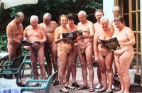 nudist photos mature mature nudist group reading magazines naturist outdoor party