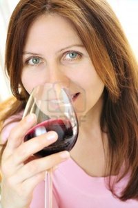 mature red elenathewise smiling mature woman holding glass red wine photo