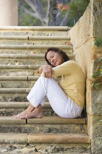 outdoor mature roboriginal portrait beautiful mature woman sitting outdoor wide limestone steps park looking relaxed stock photo